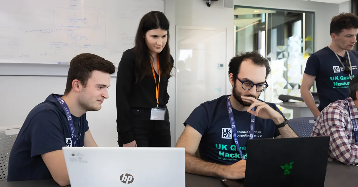 Ahmed and teammates working at laptops during the hackathon