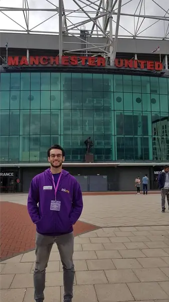 Ahmed standing outside Old Trafford stadium